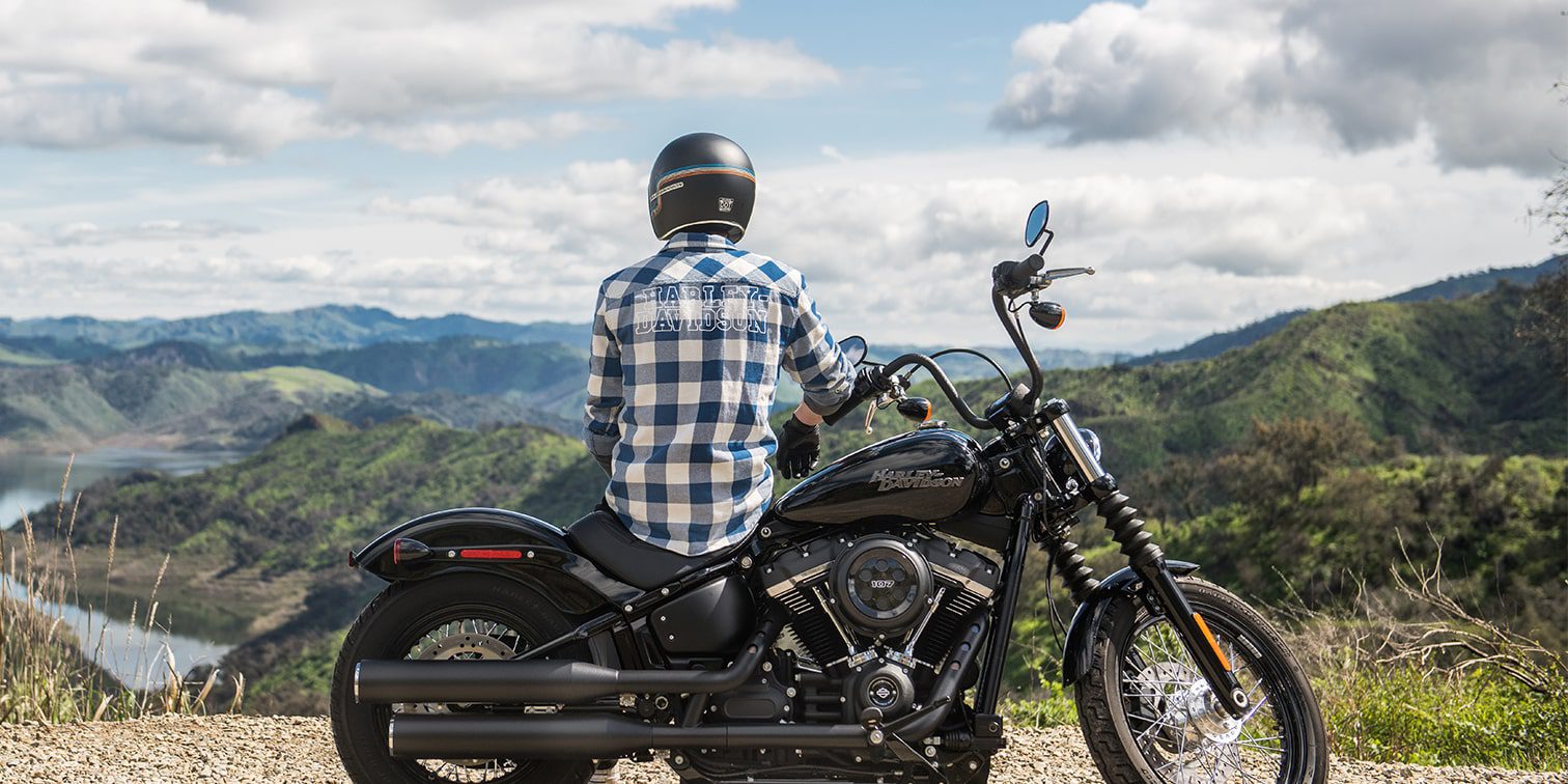 Man on a motorcycle overlooking the mountains