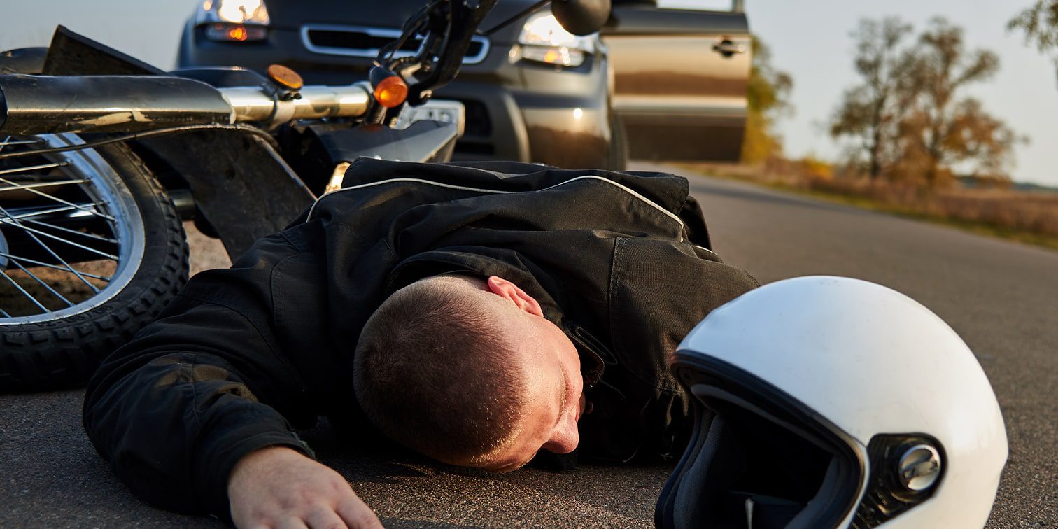 Man on the ground after a motorcycle accident