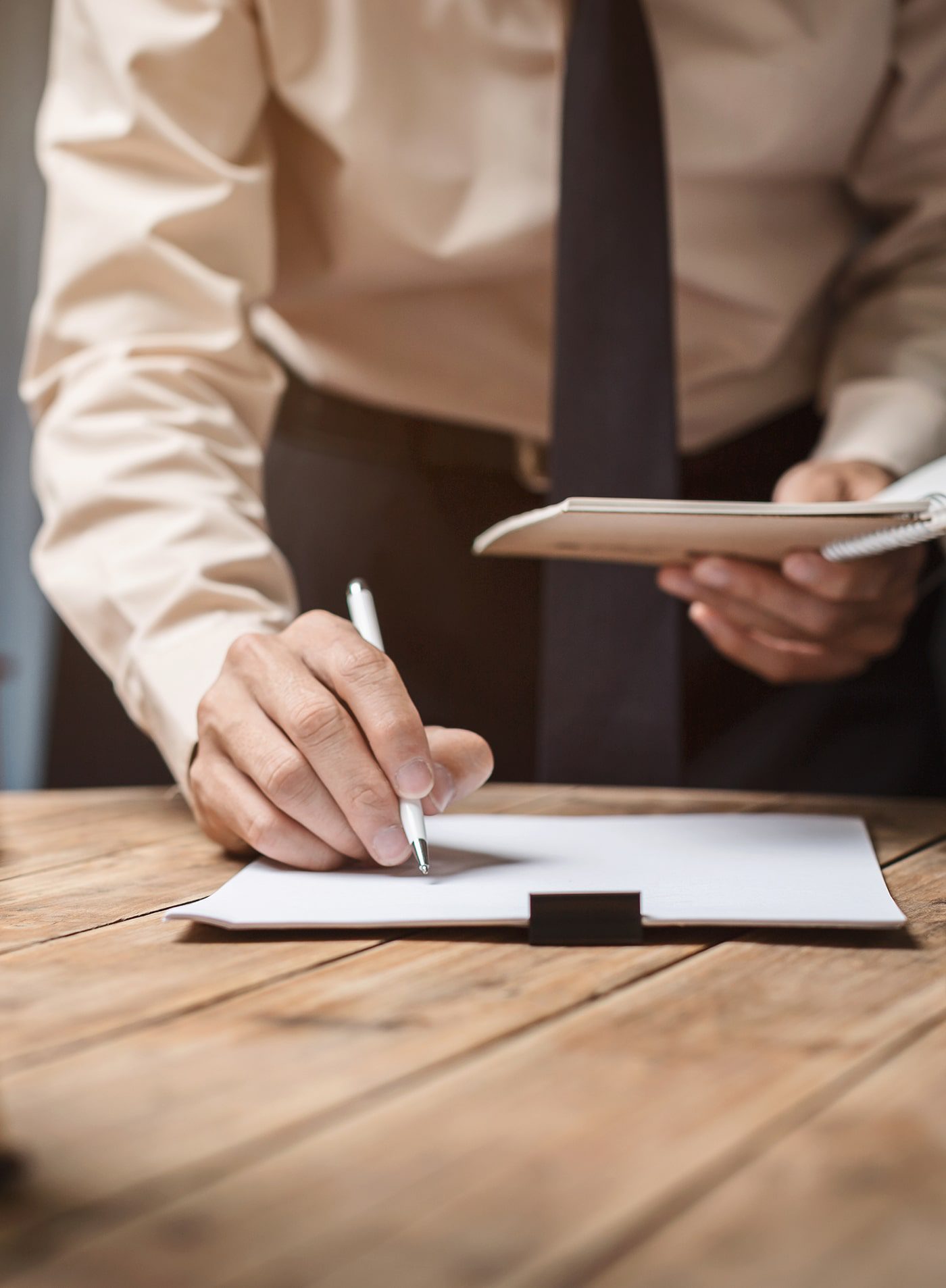 A man standing and leaning over a document