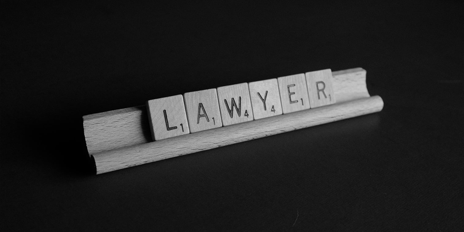 Scrabble pieces spelling the word lawyer