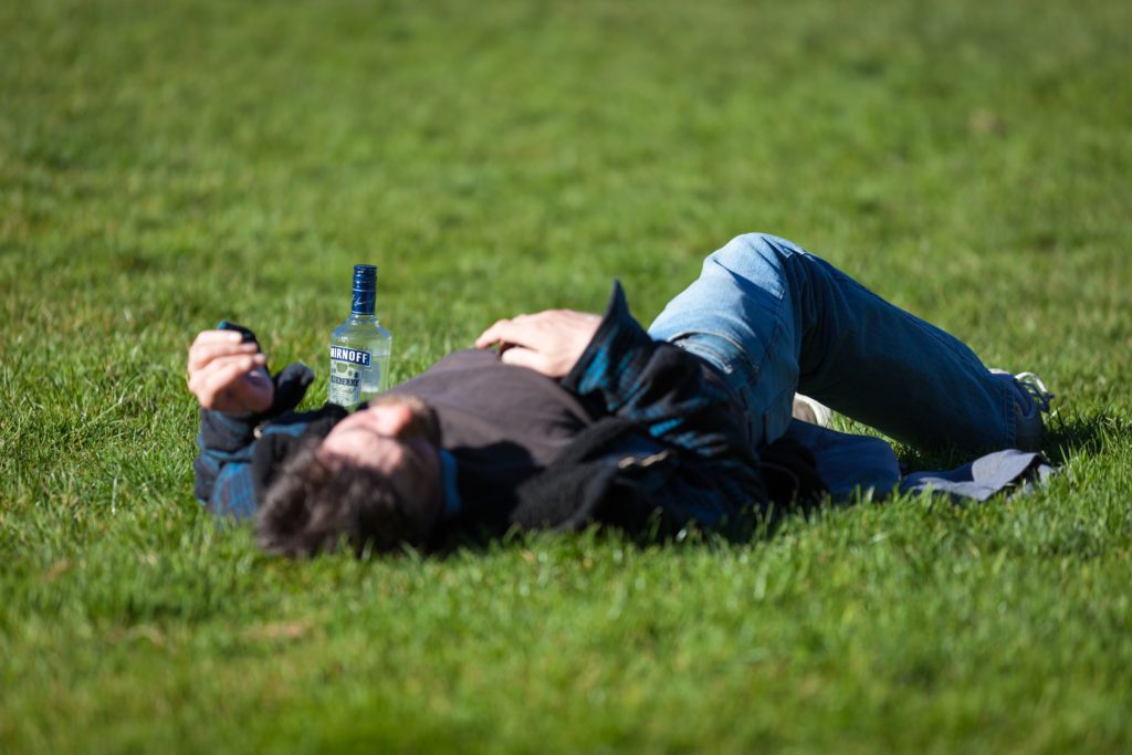 A man lying on a grass field