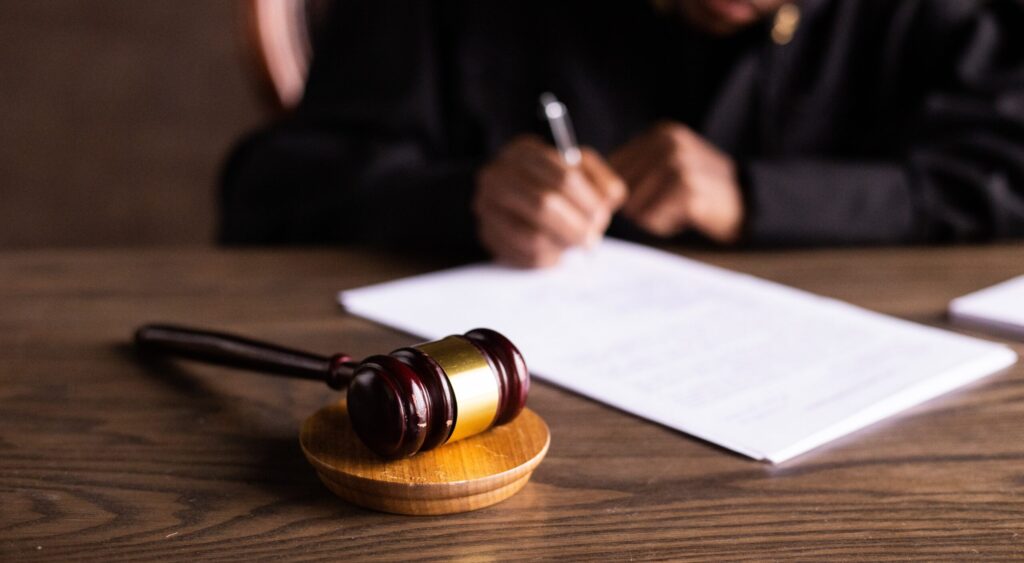 A judge’s gavel and a judge in the background