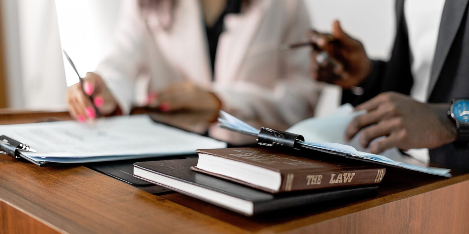 Law book on the table and two people in the background