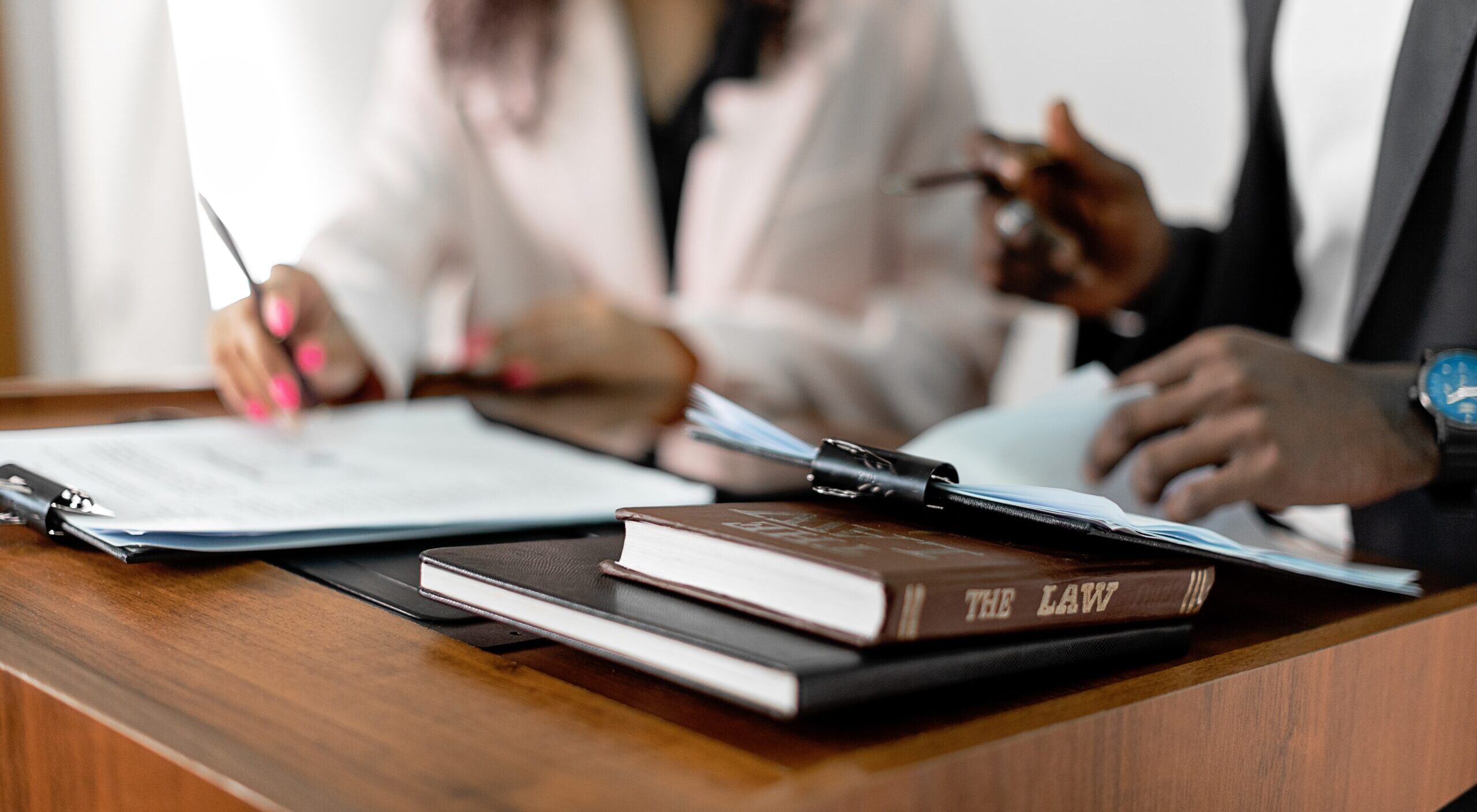 Law book on the table and two people in the background