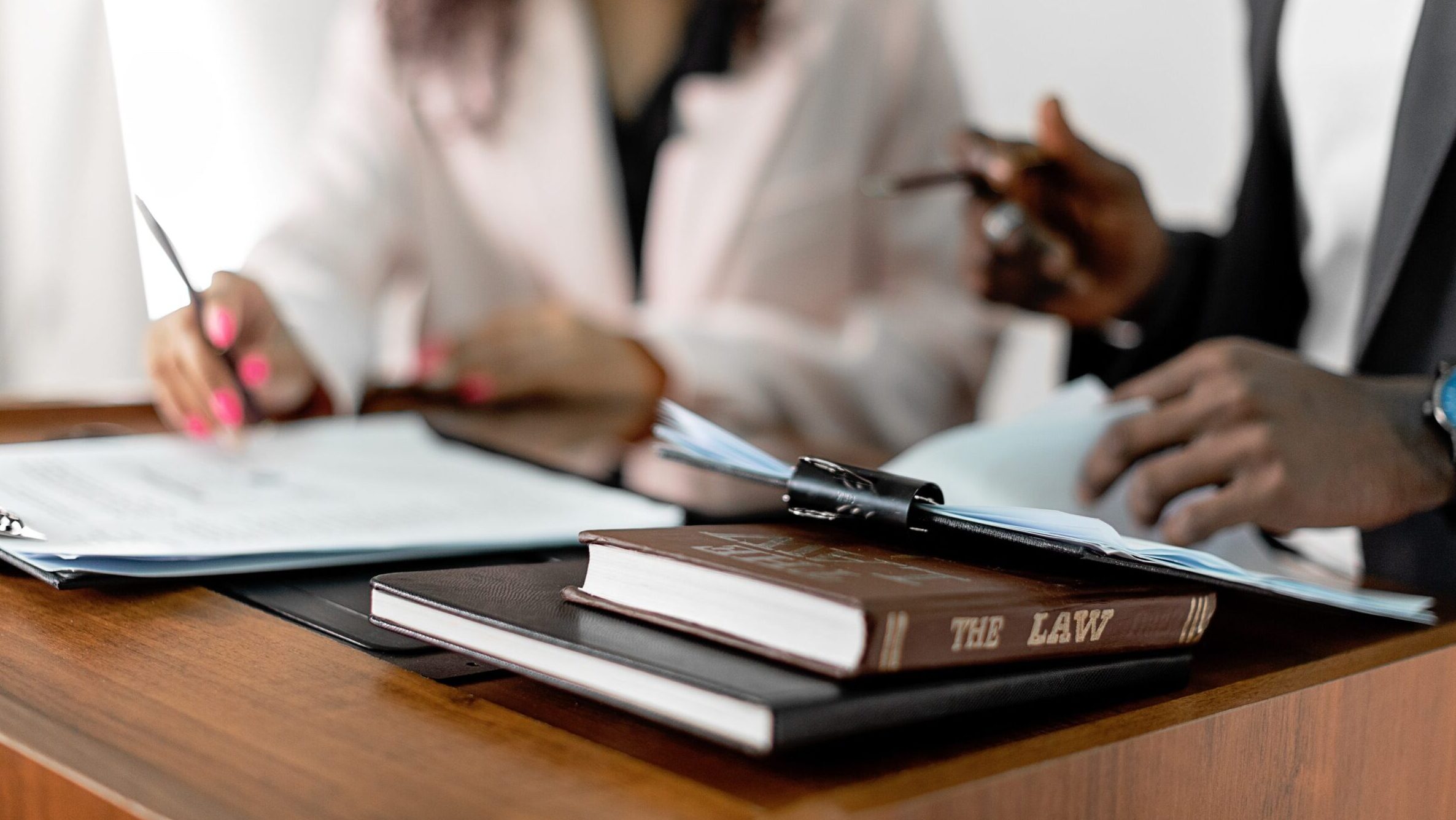 Law book on the table and two people in the background