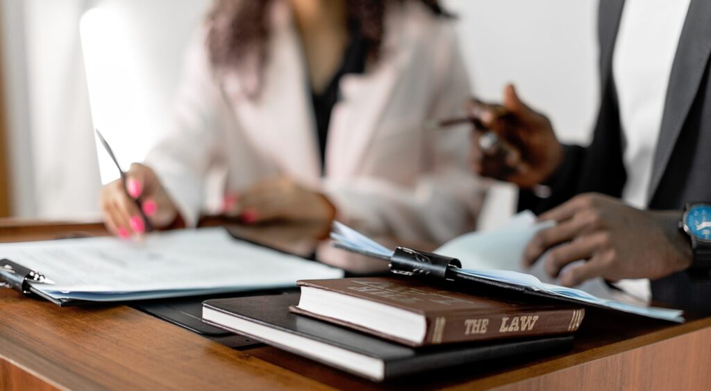 Law book on the table and two people in the background