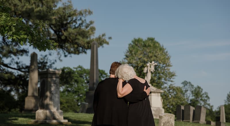 Family mourning their loved one at the graveside