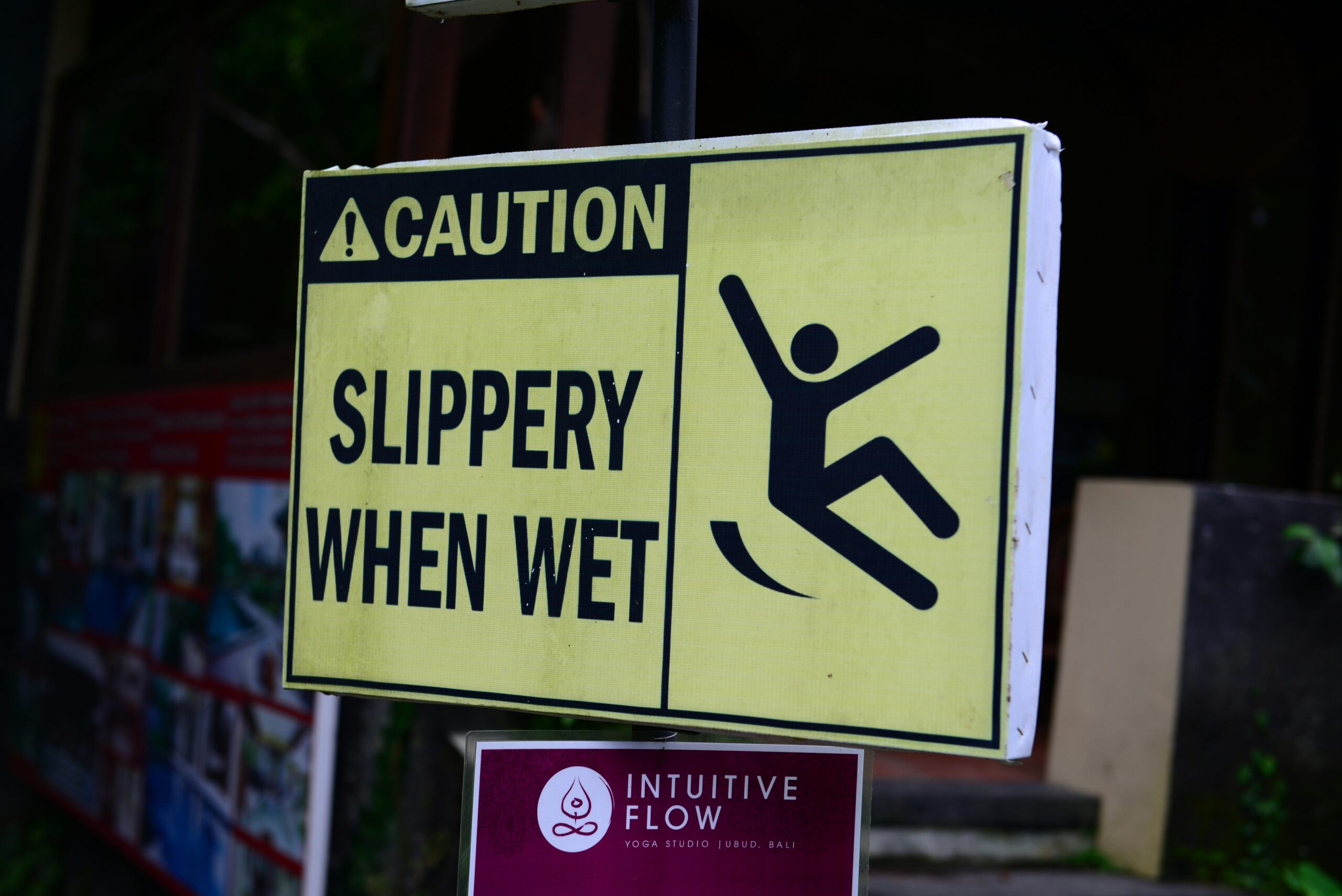 Caution sign showing wet floor in grocery store aisle