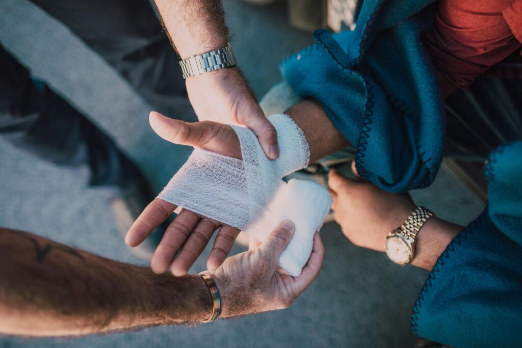 Medical professional wrapping a patient’s injured hand after an accident