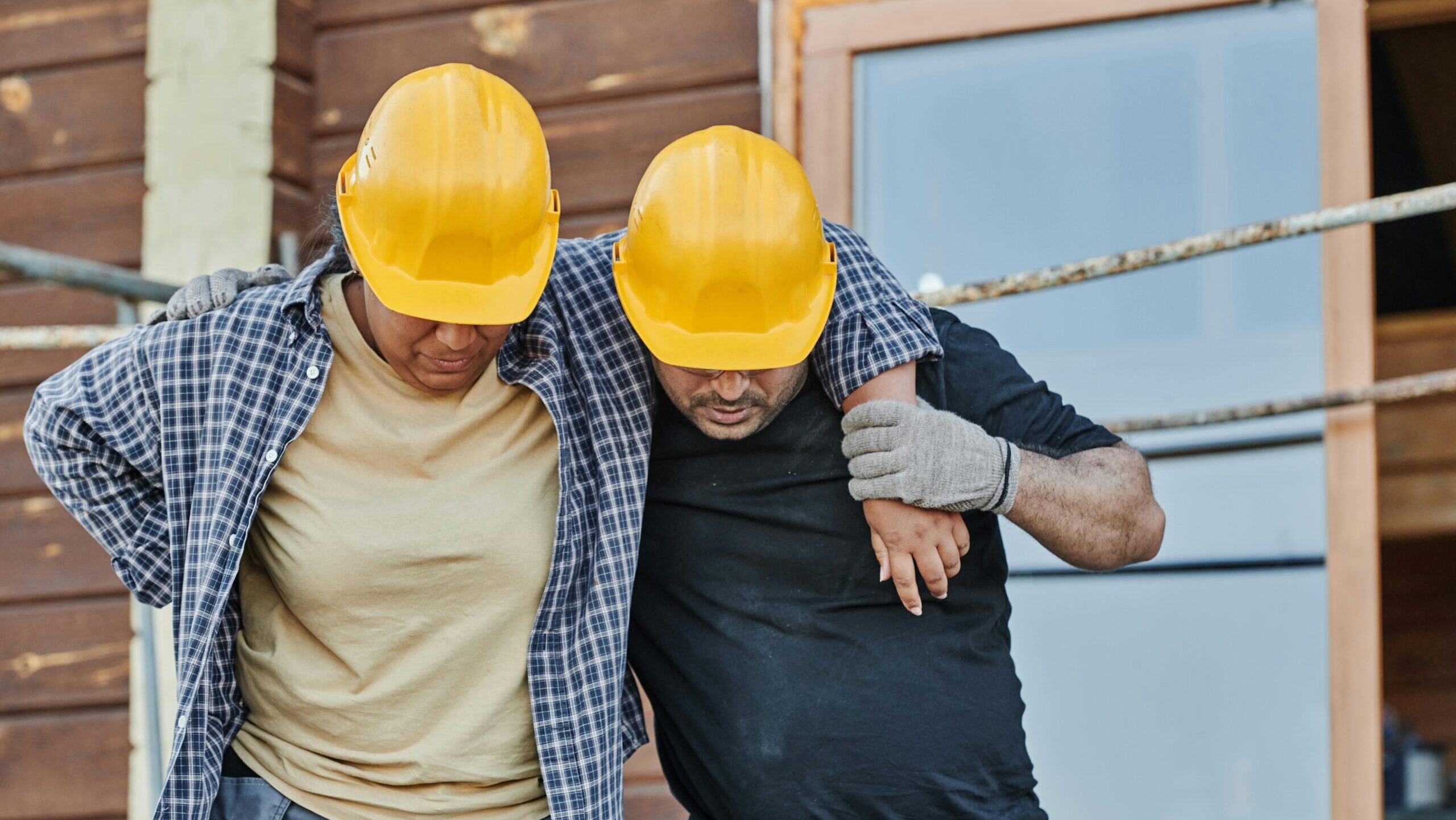 Two construction workers walking side by side at a job site