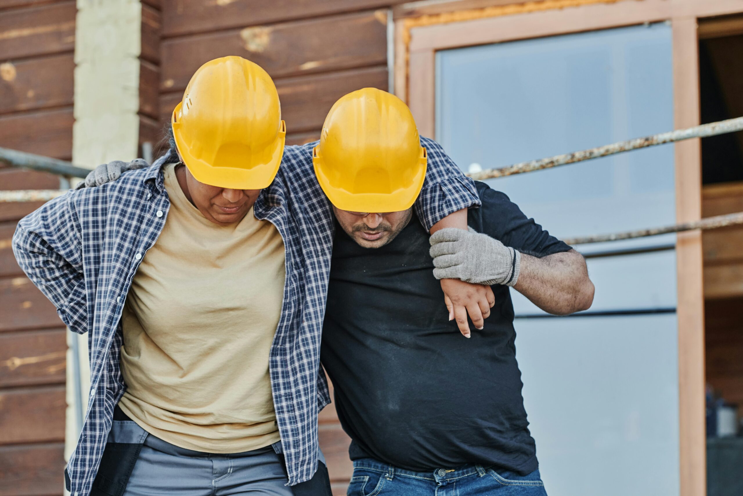 Two construction workers walking side by side at a job site